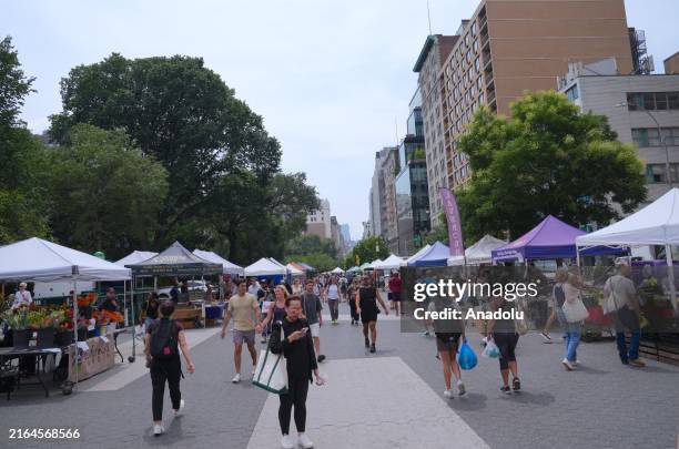 People are seen shopping at greenmarket in Union Square, which has been open 4 days a week since 1976 and offers a wide range of products including...