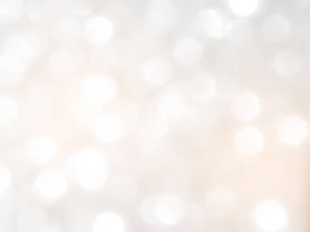 Background grey bokeh abstarct white beige circle light texture bubble blur pattern defocused glowing sparkle snow glitter snowflake magig backdrop ecosystem foreground card silver space decoration.