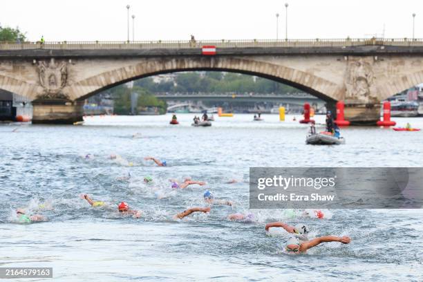 General view of athletes swimming in the Seine River during Women's Individual Triathlon on day five of the Olympic Games Paris 2024 at Pont...