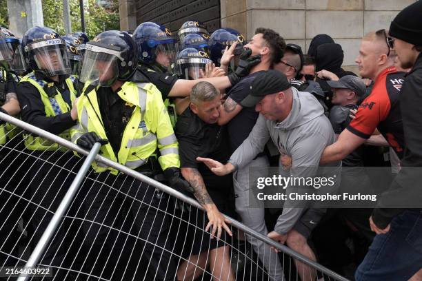 Police clash with right wing protesters in Piccadilly Gardens on August 3, 2024 in Manchester, United Kingdom. Mis-information spread on social media...
