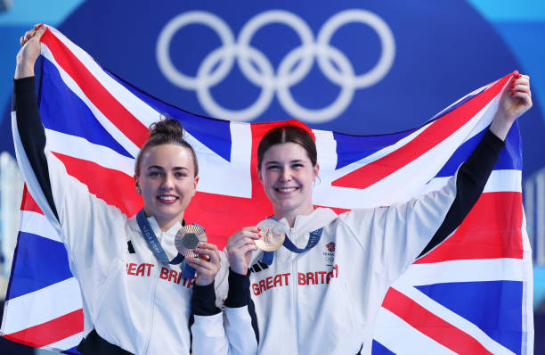 Bronze Medalists Andrea Spendolini-Sirieix and Lois Toulson of Team Great Britain pose with the national flag of Great Britain following the medal...