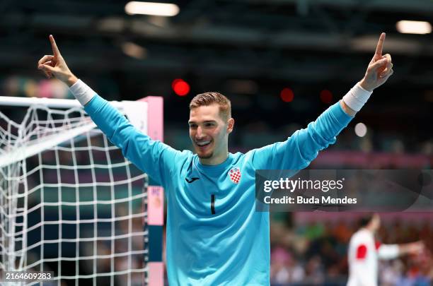 Dominik Kuzmanovic of Team Croatia celebrates after making a save during the Men's Preliminary Round - Group A match between Team Croatia and Team...