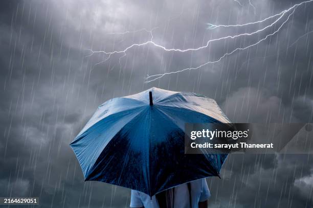 cool showers on a refreshing spring day and clear and clean raindrops bouncing on a umbrella black - väder bildbanksfoton och bilder