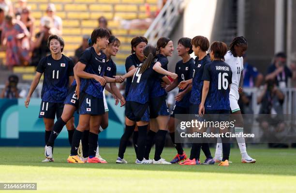 Mina Tanaka of Team Japan celebrates scoring her team's third goal with teammates during the Women's group C match between Japan and Nigeria during...