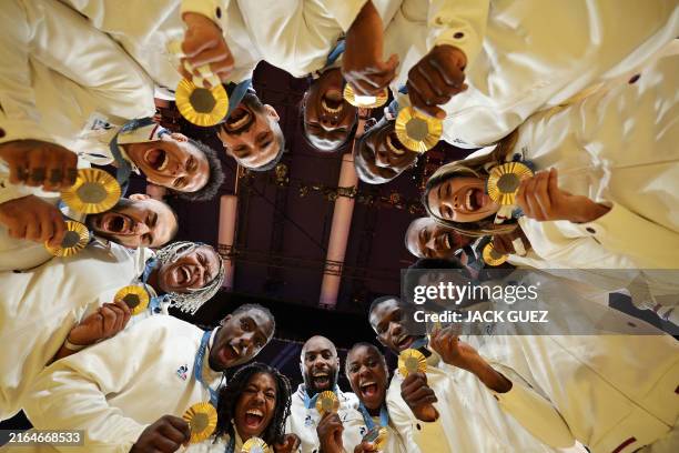Gold medallists team France pose for a photo after the podium of the judo mixed team event at the Paris 2024 Olympic Games in the Champ-de-Mars...