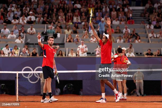 Austin Krajicek of Team United States and Rajeev Ram of Team United States celebrate to the crowd after winning match point against Rafael Nadal of...