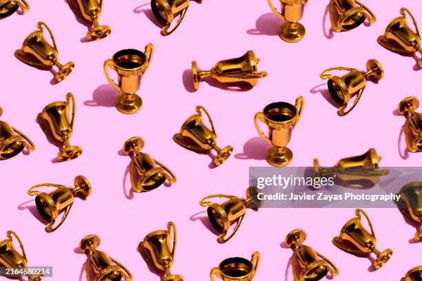 some winner cup trophies on purple background - gewinnen stock-fotos und bilder