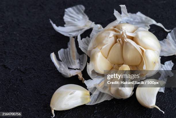 image of fresh garlic and small garlic cloves inside garlic - garlic clove stock pictures, royalty-free photos & images