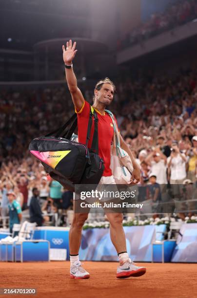 Rafael Nadal of Team Spain acknowledges the crowd as he leaves the court with partner Carlos Alcaraz of Team Spain after their Men's Doubles...