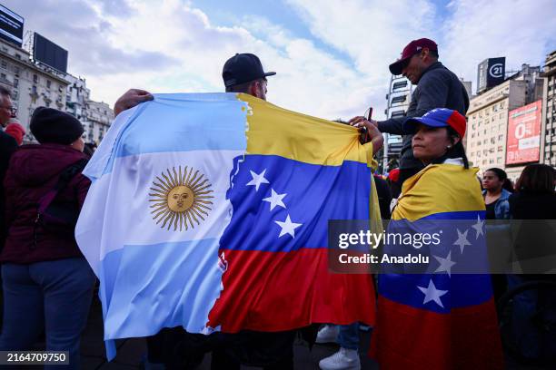 Venezuelan migrants wave flags in an Anti-government congregation, in order to denounce electoral fraud in Venezuela, the call responds to a...