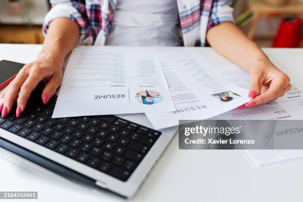 close up view of human resources female hands reading cv of job candidates - cv stock pictures, royalty-free photos & images