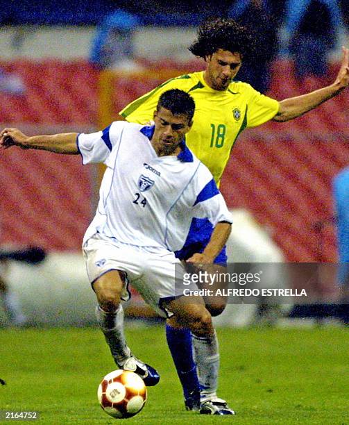 Luis Guifarro of Honduras battles with Thiago Motta of Brazil, 15 July 2003, during the Gold Cup soccer match at the Azteca stadium in Mexico City....