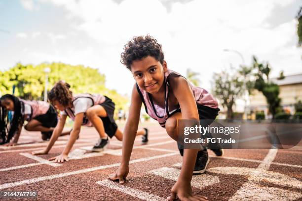 portrait of a athlete boy on a running track - athleticism stock pictures, royalty-free photos & images