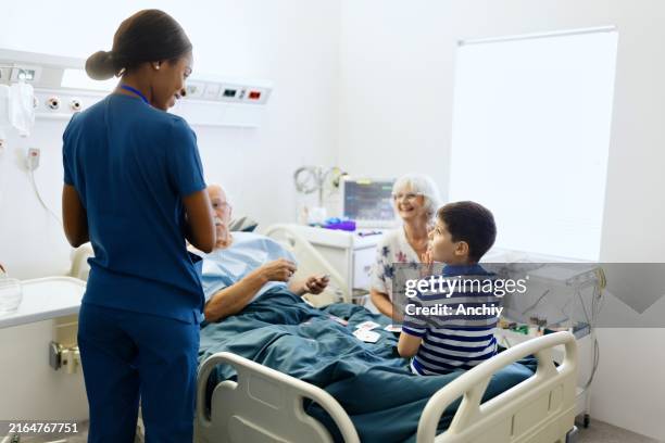 family visit at the hospital - black child hospital bed stock pictures, royalty-free photos & images