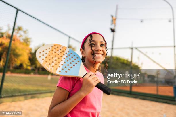 girl contemplating on tennis beach venue - preadolescent kind stockfoto's en -beelden