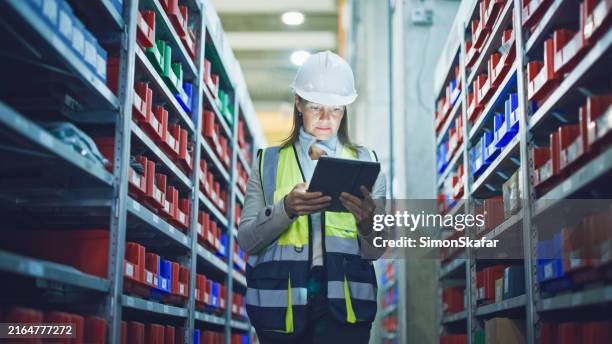 manager with tablet pc checking inventory in industry - taking inventory stock pictures, royalty-free photos & images