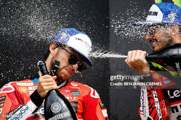 Ducati Lenovo Team's Italian rider Enea Bastianini and Ducati Lenovo Team's Italian rider Francesco Bagnaia celebrate on the podium after the MotoGP...