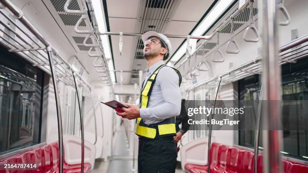 engineers who work in stations and inspect the interior of electric trains. - machinist stockfoto's en -beelden