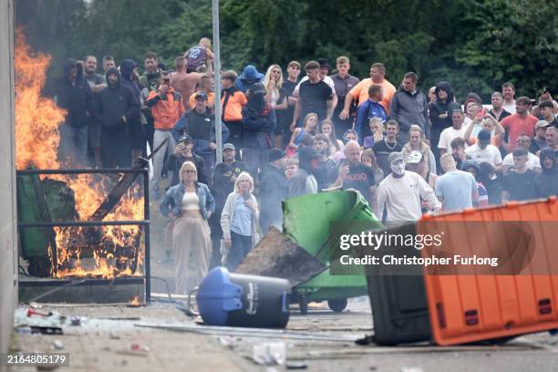 Anti-migration protesters are seen during riots outside of the Holiday Inn Express in Manvers, which is being used as an asylum hotel, on August 4,...