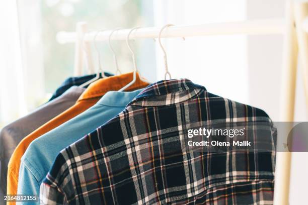colorful clothes on hangers. selling clothes concept - designerkleding stockfoto's en -beelden