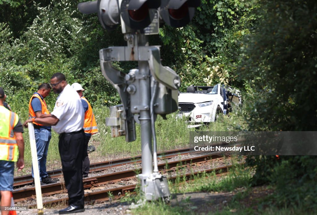 Investigators examining the Long Island Railroad track where a train hit a car
