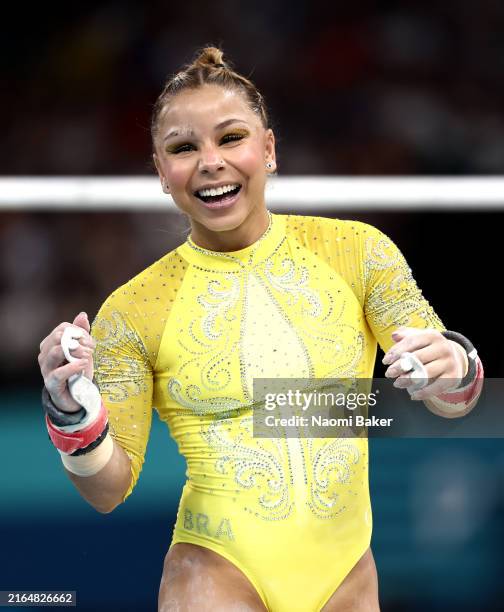 Flavia Saraiva of Team Brazil reacts after finishing her routine on the uneven bars during the Artistic Gymnastics Women's All-Around Final on day...