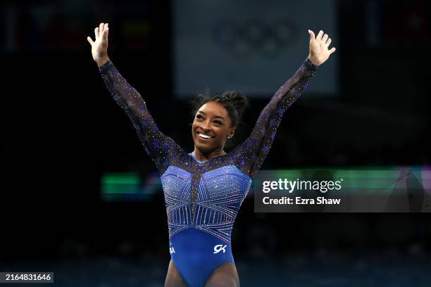 Simone Biles of Team United States reacts after finishing her routine on the balance beam during the Artistic Gymnastics Women's All-Around Final on...