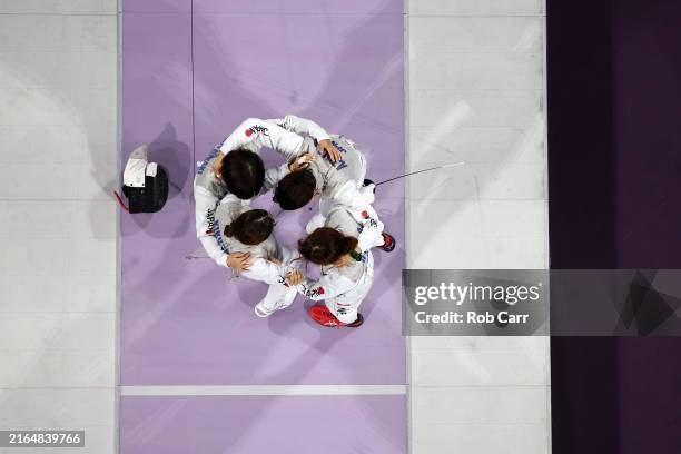 Team Japan celebrate winning the Fencing Women's Foil Team Bronze Medal match between Team Canada and Team Japan on day six of the Olympic Games...