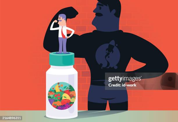 mid adult man standing on giant supplement bottle and flexing arm beside super hero shadow - flexing silhouette vector stock illustrations