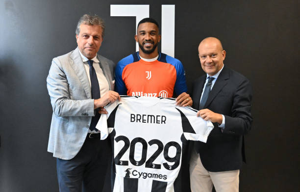 Juventus Extend Contract of Gleison Bremer pictured with Cristiano Giuntoli, Juventus Managing Director of Football and Maurizio Scanavino, CEO of...
