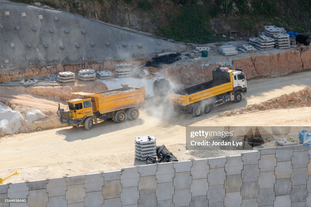 Dump trucks carrying dirt on construction site