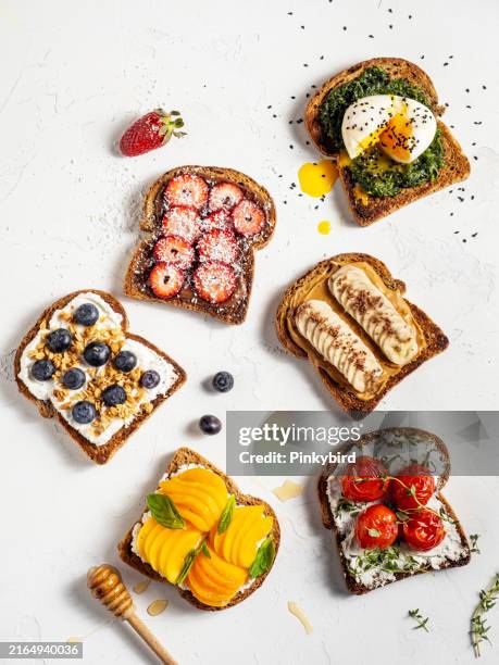 healthy vegetarian toasts with cream cheese, fruits. summer fresh fruit toast sandwich. crostini. bruschetta. eggs benedict with spinach. bruschetta food choices. small sandwiches. toasted bread with cheese and roasted cherry tomato. - antioxidant berries stock pictures, royalty-free photos & images