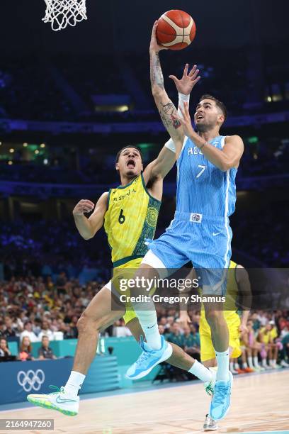 Vasileios Toliopoulos of Team Greece drives to the basket against Josh Green of Team Australia during the Men's Group Phase - Group A match between...