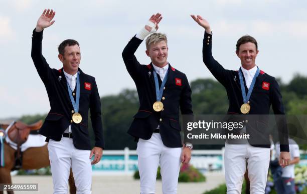 Gold medalists Scott Brash, Harry Charles and Ben Maher of Team Great Britain celebrate during the medal ceremony for the Jumping Team Final on day...