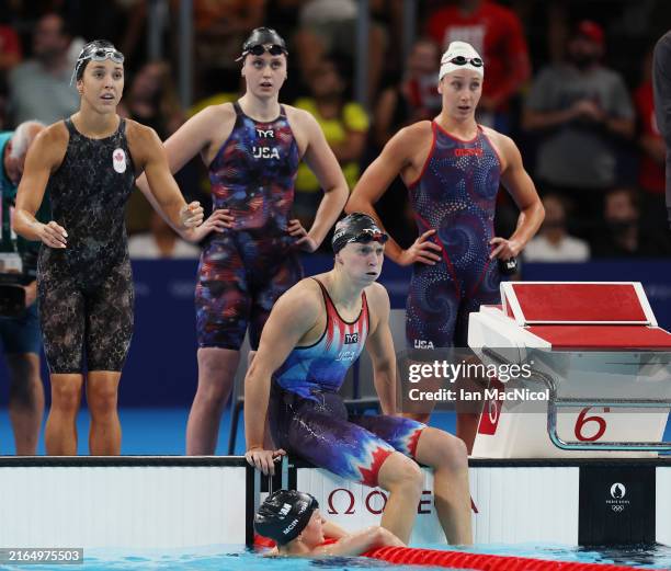 Claire Weinstein, Paige Madden, Katie Ledecky and Erin Gemmell of Team United States react after taking silver in the Women's 4x200m Freestyle Relay...