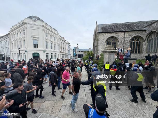 Police officers intervene as anti-racism activists gather at Guildhall square to face off far-right protesters after they announce a protest in...