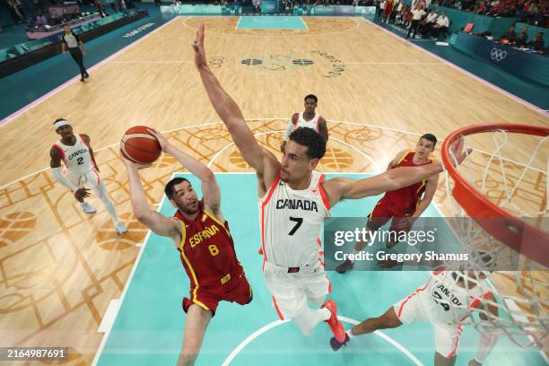 Dario Brizuela of Team Spain goes up for a basket past Dwight Powell of Team Canada during the Men's Group Phase - Group A game between Team Canada...