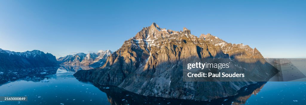Aerial View of Midnight Sun on Mountains along Uummannaq Fjord, Greenland