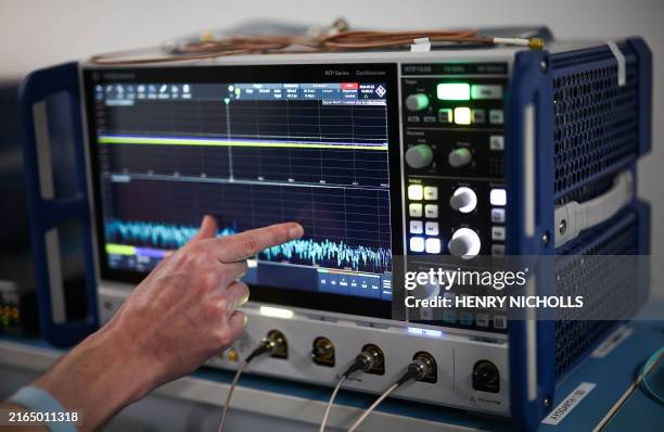Staff member adjusts an oscilloscope inside the hardware lab at Riverlane in Cambridge, eastern England on July 25, 2024. Promising society-changing...
