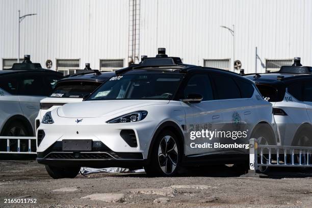 Baidu Inc. Driverless robotaxis in a parking lot in Wuhan, China, on Monday, July 22, 2024. More than 500 electric robotaxis built by Baidu currently...