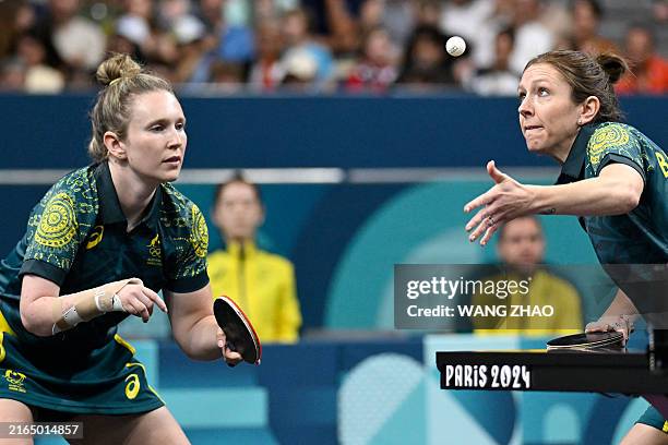 Australia's Michelle Bromley serves as Australia's Melissa Tapper reacts during their women's table tennis doubles match in the team round of 16...