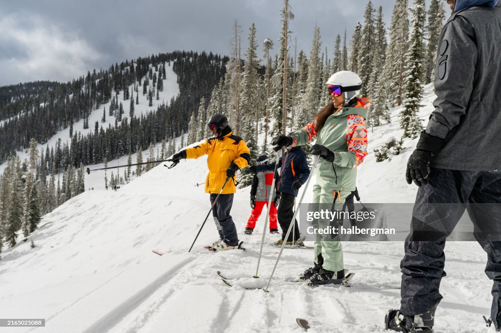 Skiers and Snowboarders Looking Out at View