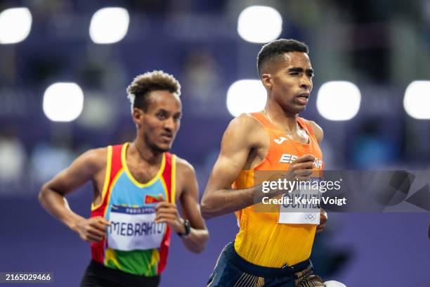 Merhawi Mebrahtu of Team Eritrea and Abdessamad Oukhelfen of Team Spain competes during the Men's 10.000 Metres final on day seven of the Olympic...