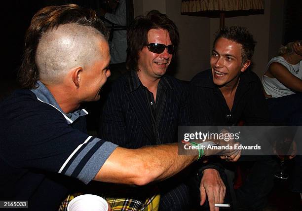 No Doubt' drummer Adrian Young chats with guitarist Andy Taylor and his son Andy Jr. At an after-party at the Chateau Marmont on July 15, 2003 in...
