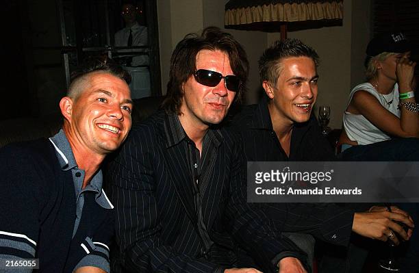 No Doubt' drummer Adrian Young poses with guitarist Andy Taylor and his son Andy Jr. At an after-party at the Chateau Marmont on July 15, 2003 in...