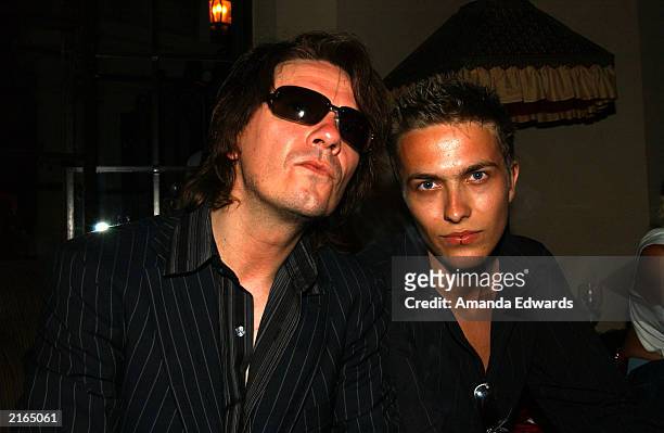 Guitarist Andy Taylor and his son Andy Jr. Pose at an after-party at the Chateau Marmont on July 15, 2003 in Hollywood, California. The party...