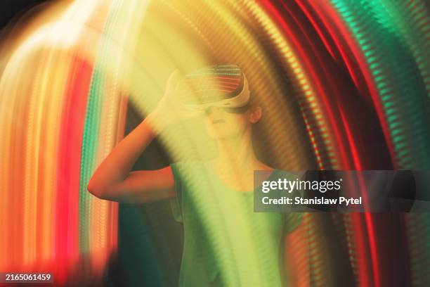 girl using vr googles surrounded by colorful lights - animation stock pictures, royalty-free photos & images
