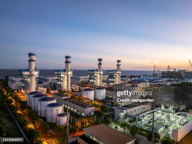 aerial view of natural gas fired electrical power plant at sunset - centrale elettrica foto e immagini stock
