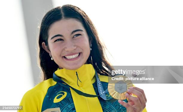 August 2024, France, Paris: Olympia, Paris 2024, Skateboard, Park, Women, Final, Arisa Trew from Australia cheers with the gold medal at the award...