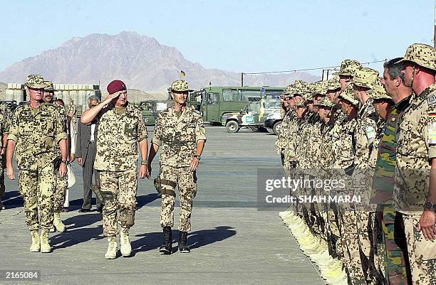 German Air Force Colonel Uwe Aherns , German Brigadier General Werner Freers , and German Colonel Martin Schelleis inspect German and Belgian troops...